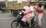 1.	Six people ride on one motorbike as they move to higher ground following an earthquake off Banda Aceh